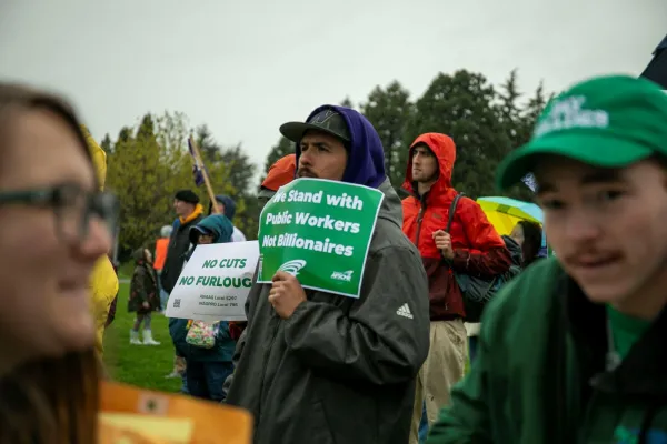 members at a rally with signs