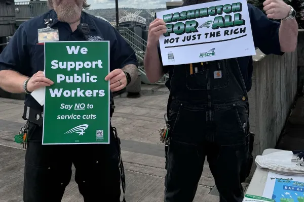 members holding signs Washington For All Not Just the Rich at Harborview Medical Center
