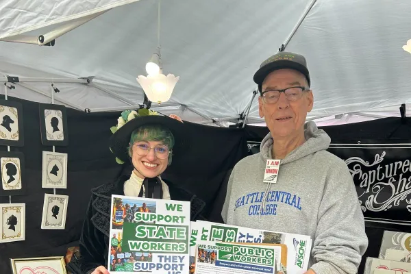 Business leaders holding signs that say we support state workers, we support uw workers, and we support community college workers