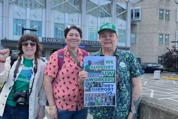 Business leaders holding signs that say we support state workers, we support uw workers, and we support community college workers