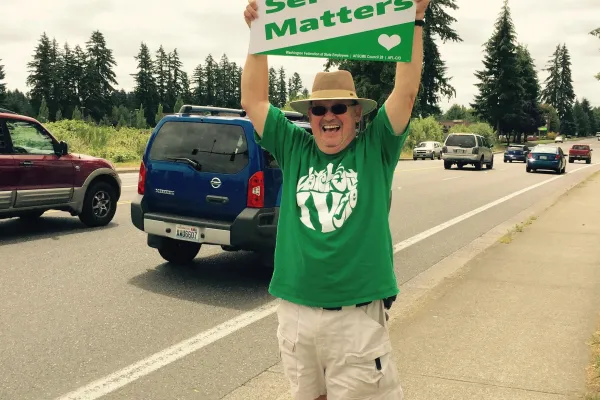 tim_hughes_with_sign.jpg