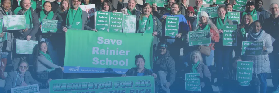 Photo of WFSE members in green shirts holding rally sign and a large sign that says "Washington is for All, Not Just The Rich"