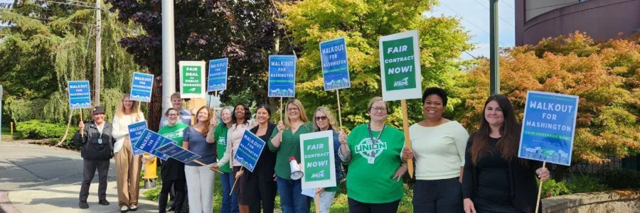 Photo of Local 795 members with picket signs in green shirts