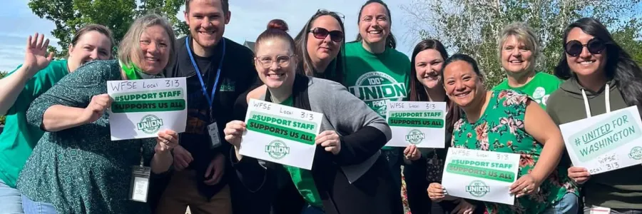 WFSE Local 313 members wearing green hold signs that say Support Staff Support Us All