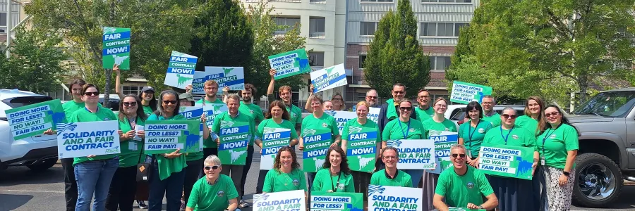 group photo of people holding solidarity signs