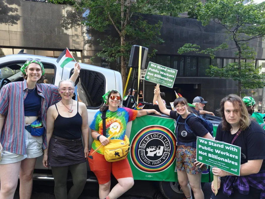 A group of Local 1495 siblings with signs for Pride Parade