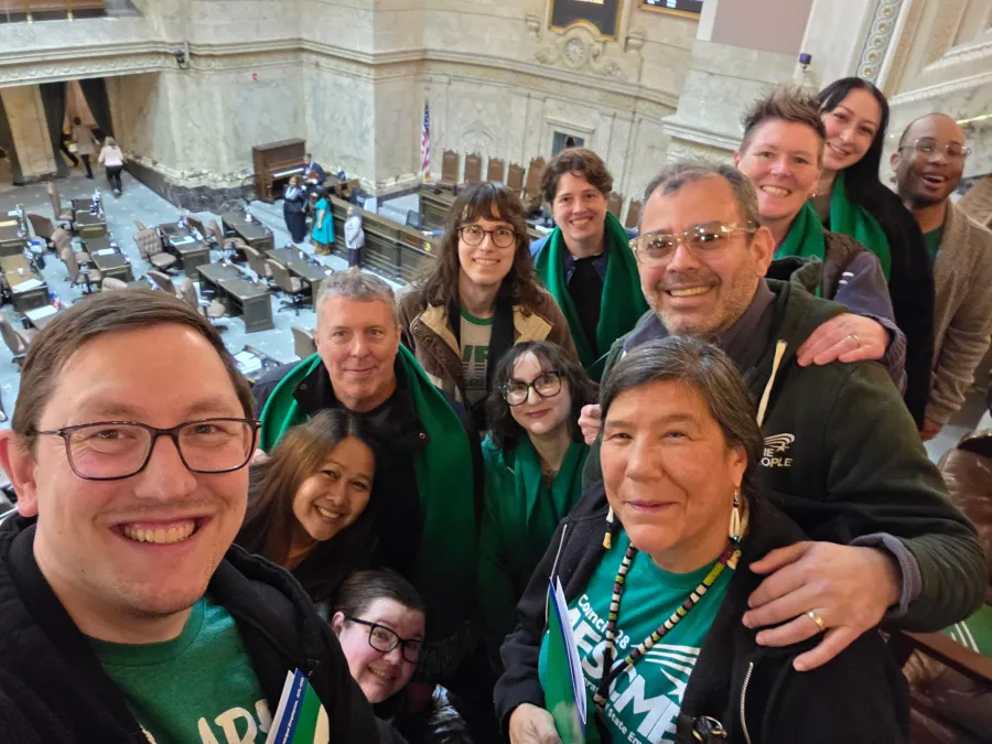 WFSE members face the camera with the floor of the WA State House in the background