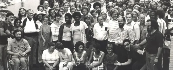 Historical black and white photo of WFSE members from many different backgrounds smiling for a large group photo.