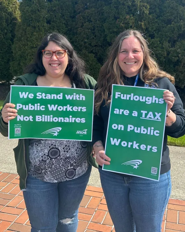 members holding no furloughs signs