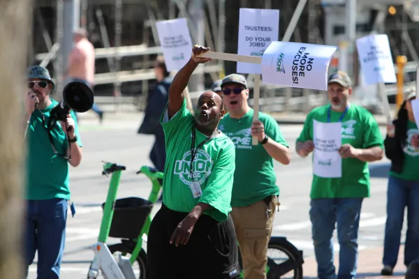 WFSE Member at Seattle Colleges holds a picket sign