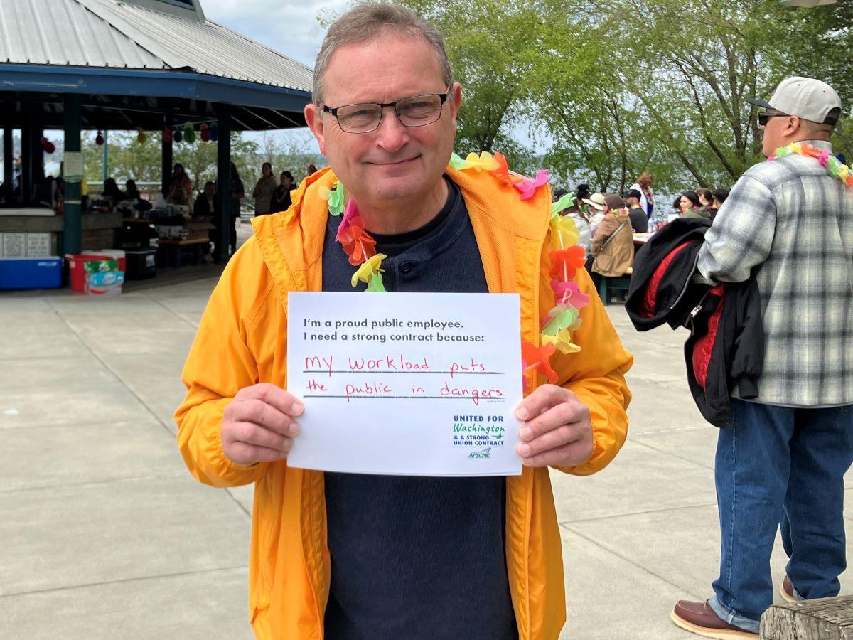 WFSE DOC member hoilding a sign saying My Workload Puts the Public in Danger